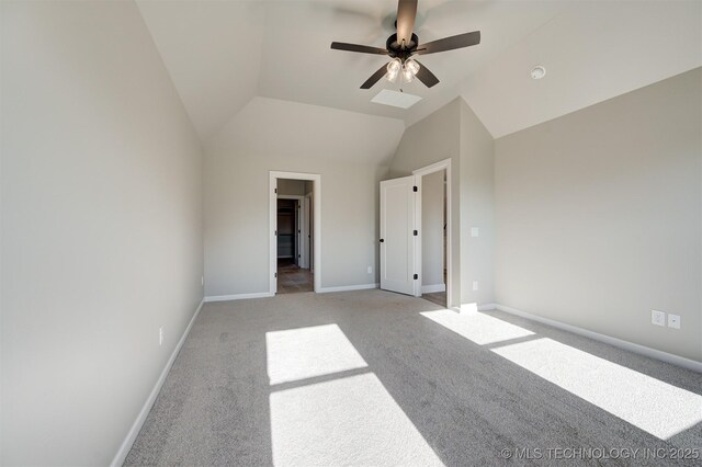 unfurnished bedroom with light colored carpet, vaulted ceiling, ceiling fan, and a spacious closet