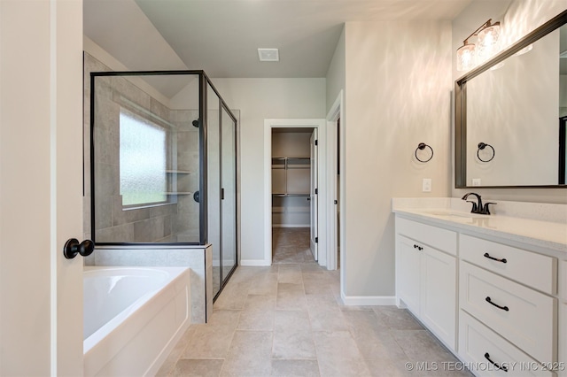 bathroom with tile patterned flooring, vanity, and shower with separate bathtub