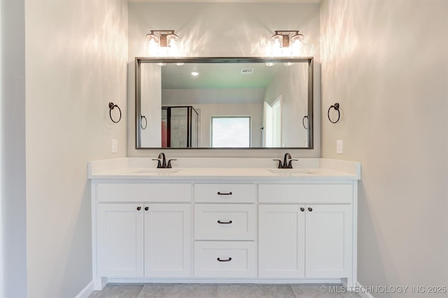 bathroom featuring walk in shower, tile patterned floors, and vanity