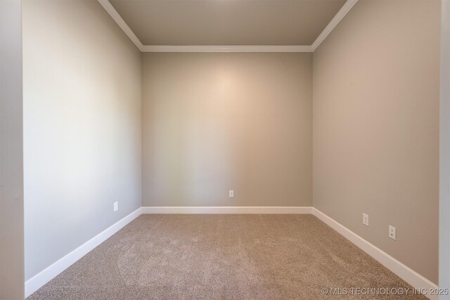 carpeted spare room featuring crown molding