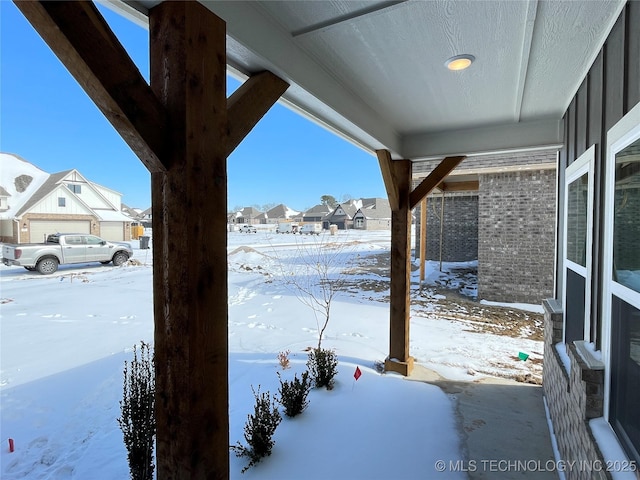 snowy yard with a residential view