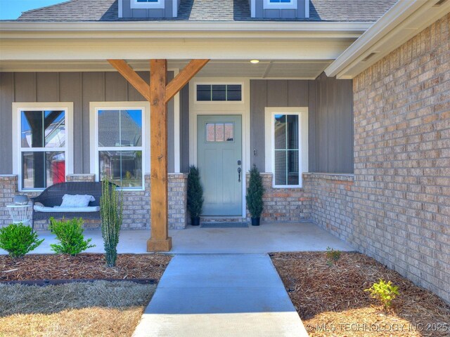 7113 E Princeton St, Broken Arrow, OK 74014 - property entrance featuring board and batten siding, a porch, and a shingled roof