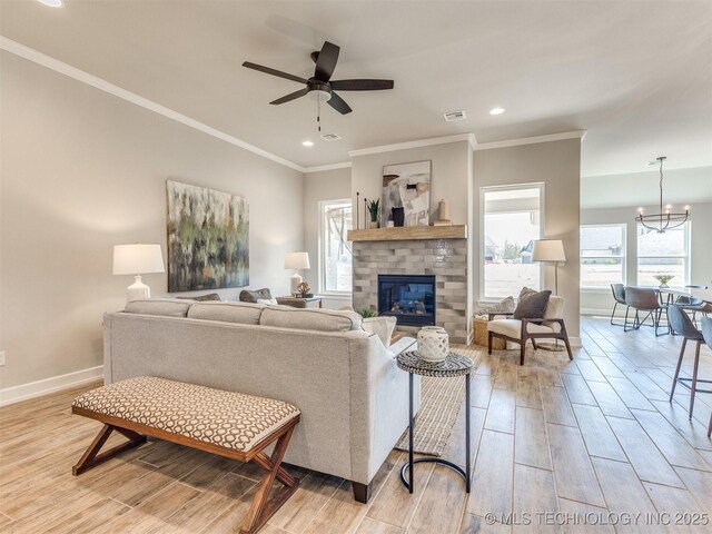 7113 E Princeton St, Broken Arrow, OK 74014 - living room featuring light wood-style floors, a fireplace, crown molding, ceiling fan, and recessed lighting