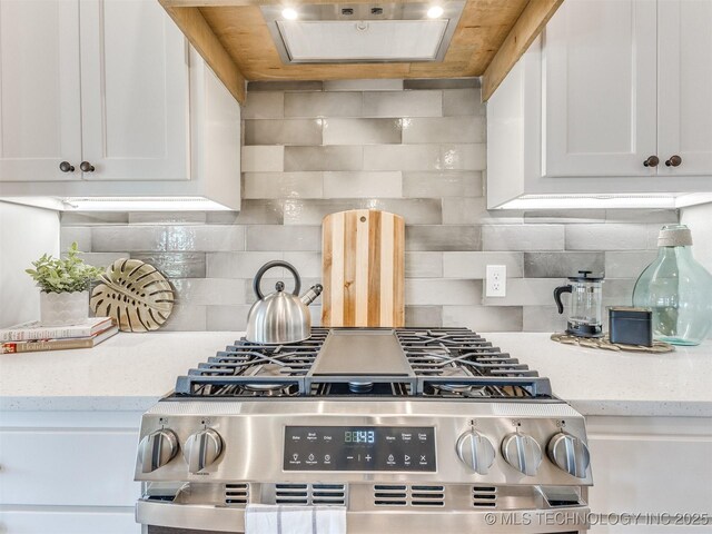 7113 E Princeton St, Broken Arrow, OK 74014 - kitchen featuring stainless steel range with gas cooktop, white cabinetry, and decorative backsplash