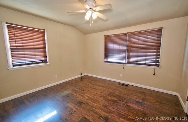 spare room with ceiling fan, dark hardwood / wood-style flooring, and vaulted ceiling