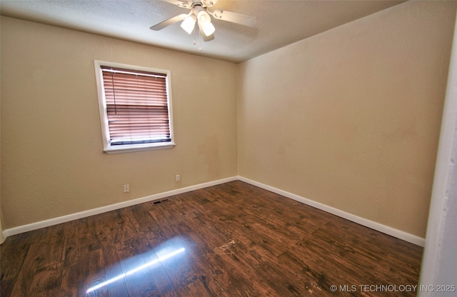 spare room featuring ceiling fan, a textured ceiling, and dark hardwood / wood-style floors