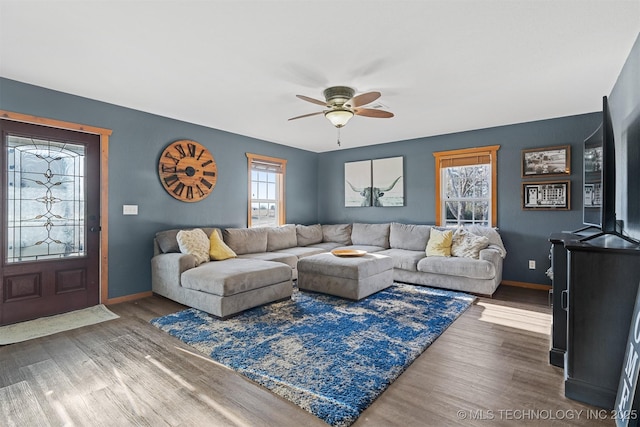 living room with wood-type flooring and ceiling fan