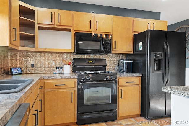 kitchen with sink, light tile patterned floors, black appliances, and tasteful backsplash