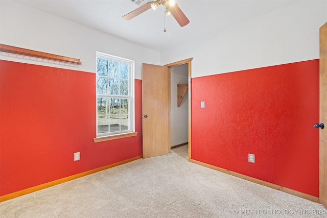 carpeted empty room with ceiling fan