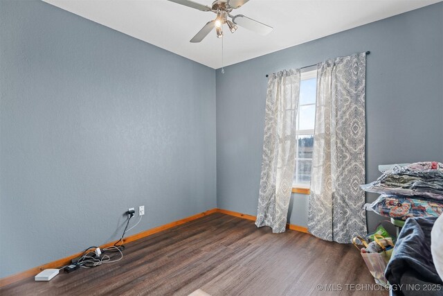 spare room featuring dark hardwood / wood-style floors and ceiling fan