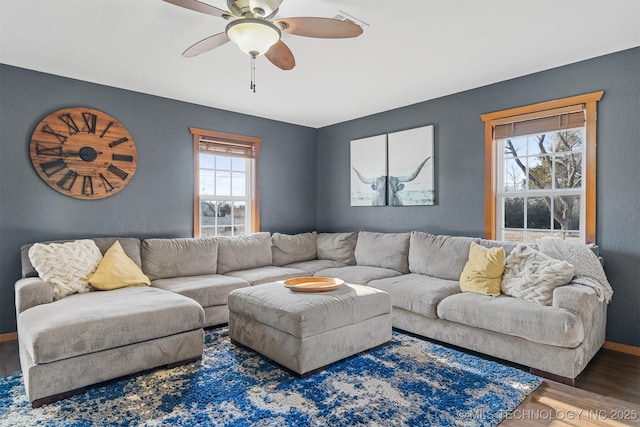 living room with dark hardwood / wood-style flooring and ceiling fan