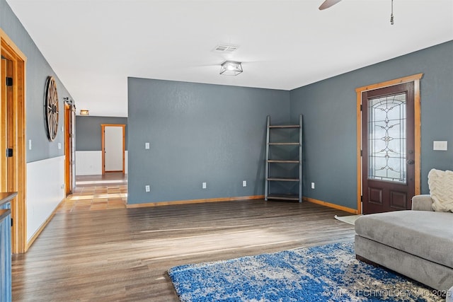 living room with hardwood / wood-style floors and ceiling fan