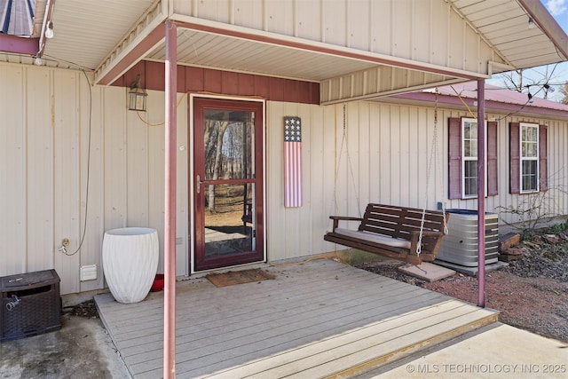 doorway to property featuring a wooden deck and central air condition unit