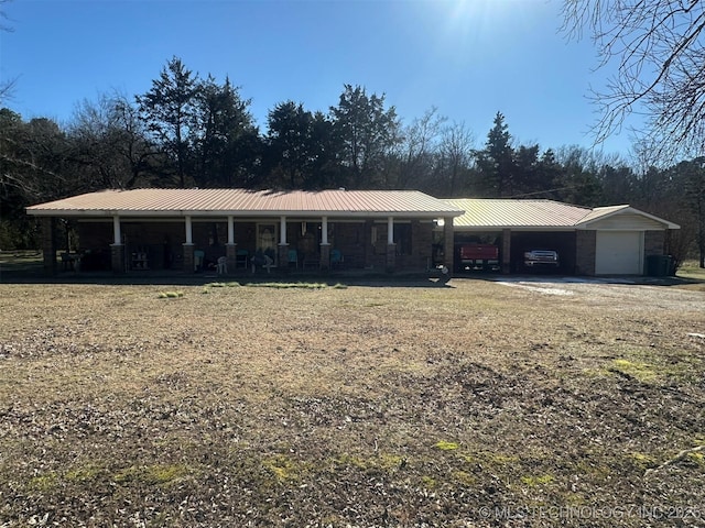 view of front of property with a carport and a garage