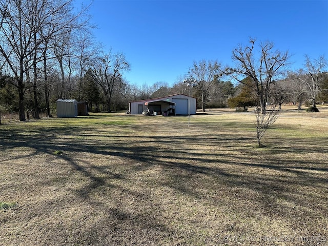 view of yard with a carport and a storage unit