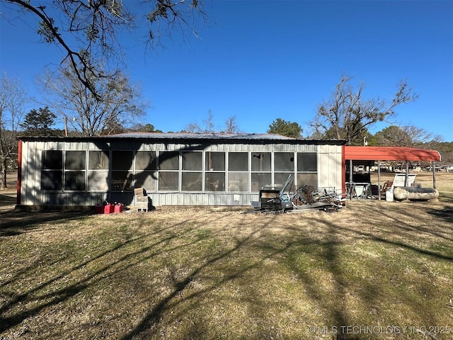 back of property with a lawn