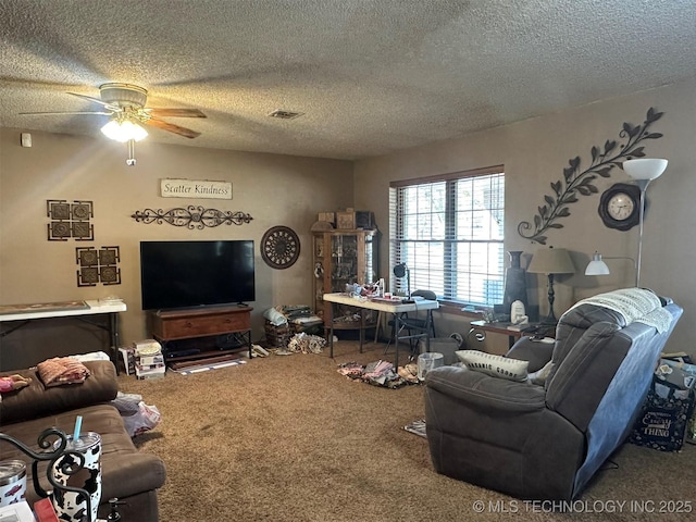 living room with a textured ceiling, carpet floors, and ceiling fan