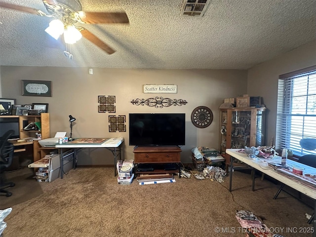 interior space featuring ceiling fan and a textured ceiling