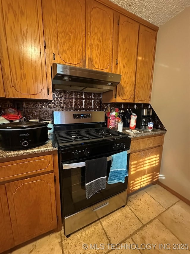 kitchen with a textured ceiling and gas range