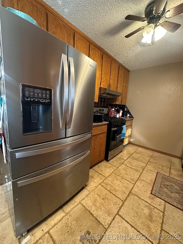 kitchen featuring ceiling fan, a textured ceiling, and stainless steel appliances