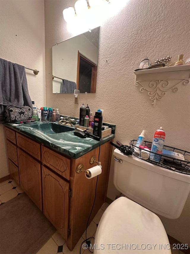 bathroom with vanity, toilet, and tile patterned floors