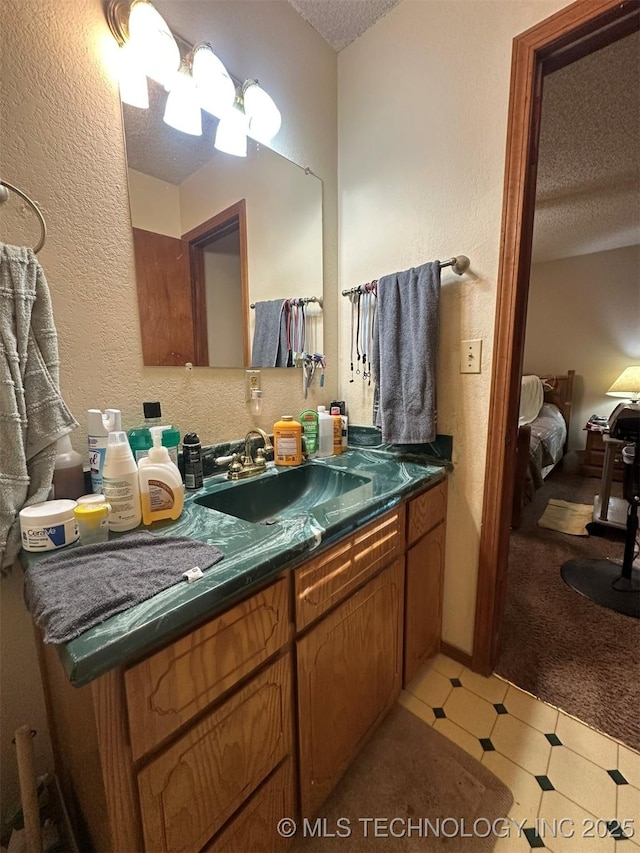 bathroom featuring vanity and a textured ceiling