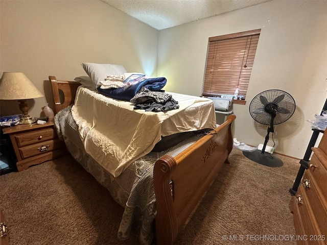 bedroom featuring dark carpet and a textured ceiling