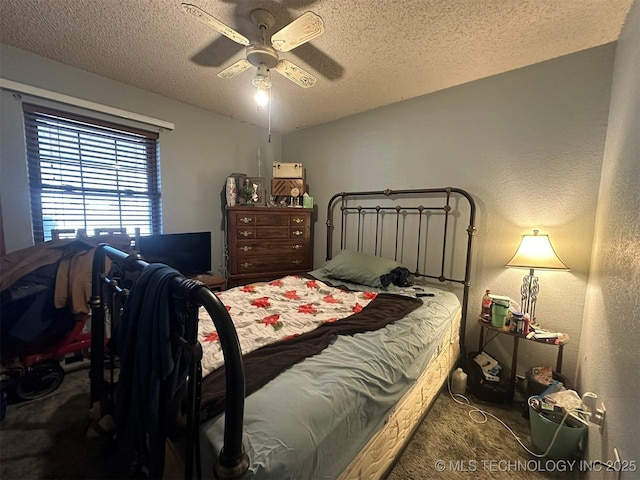 carpeted bedroom with a textured ceiling and ceiling fan