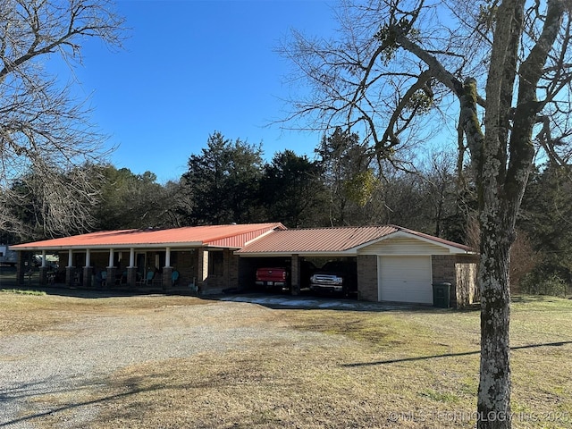 ranch-style home with a garage, a front yard, and a carport