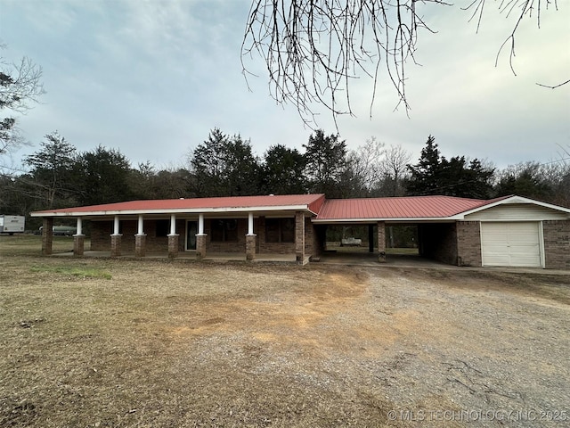 single story home featuring a garage and a carport