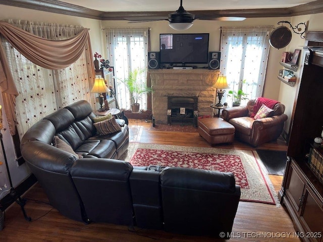 living room with hardwood / wood-style flooring, ornamental molding, and ceiling fan