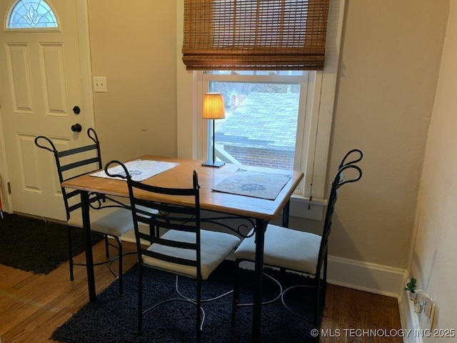 dining area with dark wood-type flooring