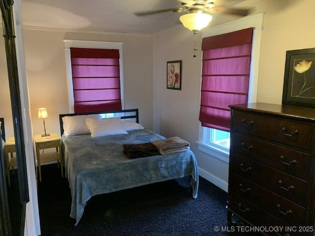 carpeted bedroom featuring ornamental molding and ceiling fan