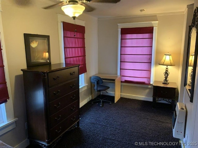 carpeted office space featuring crown molding and ceiling fan