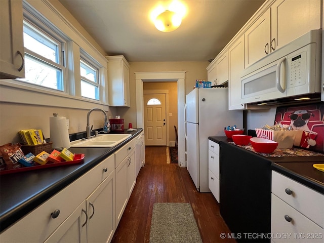 kitchen featuring sink, white appliances, dark hardwood / wood-style floors, and white cabinets