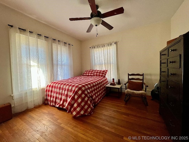 bedroom with hardwood / wood-style floors and ceiling fan