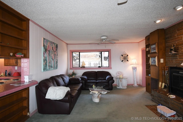 living room featuring ornamental molding, a fireplace, carpet, and a textured ceiling