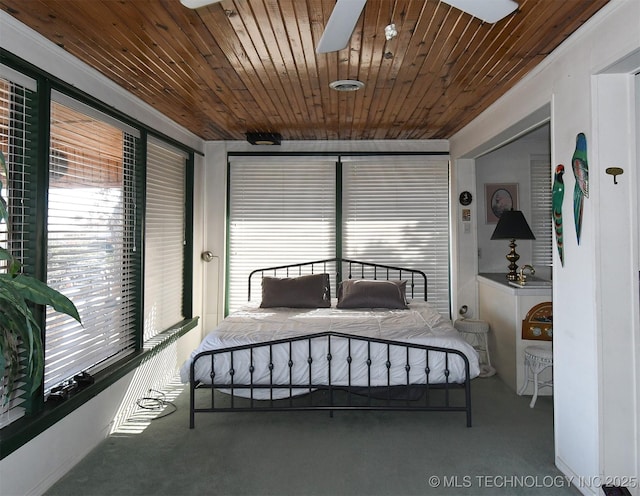 carpeted bedroom featuring multiple windows and wooden ceiling