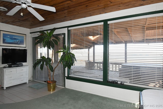 interior space with wood ceiling and ceiling fan