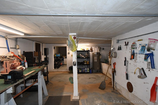 basement with a workshop area and water heater