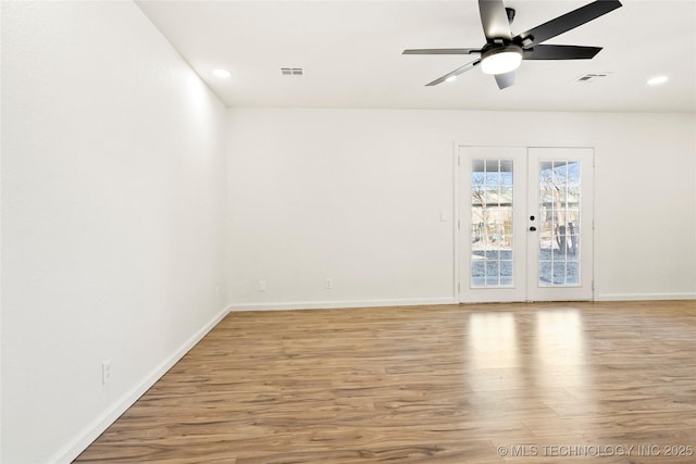 unfurnished room with hardwood / wood-style flooring, ceiling fan, and french doors