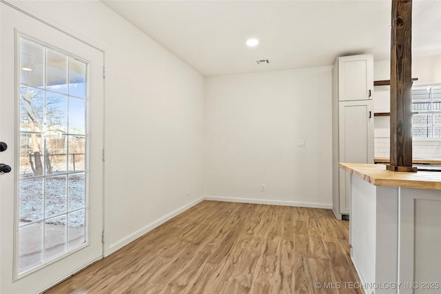 unfurnished dining area with light hardwood / wood-style flooring