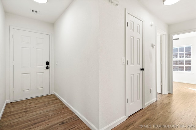 hallway with hardwood / wood-style floors