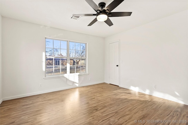 empty room featuring ceiling fan and light hardwood / wood-style floors