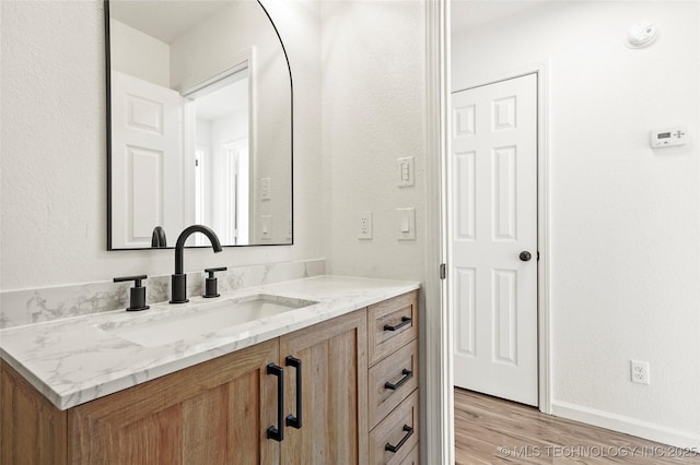 bathroom with hardwood / wood-style flooring and vanity