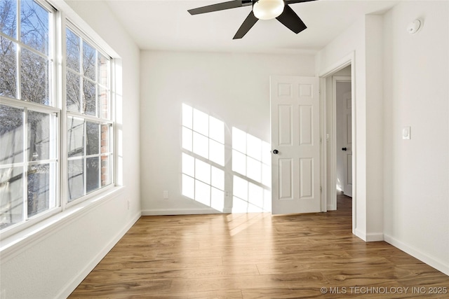 unfurnished room with hardwood / wood-style flooring and ceiling fan