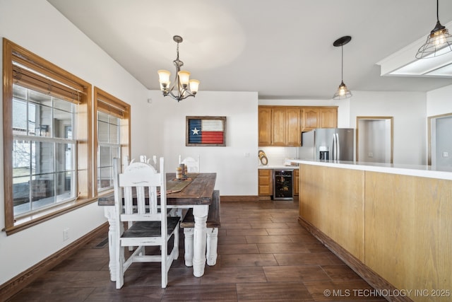 dining space with a notable chandelier and beverage cooler