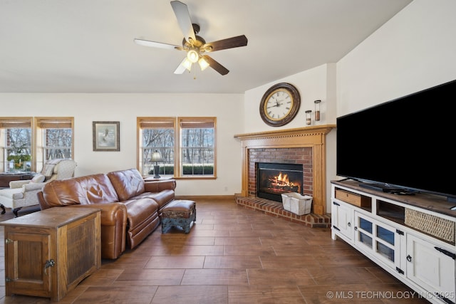 living room featuring a fireplace, a healthy amount of sunlight, and ceiling fan