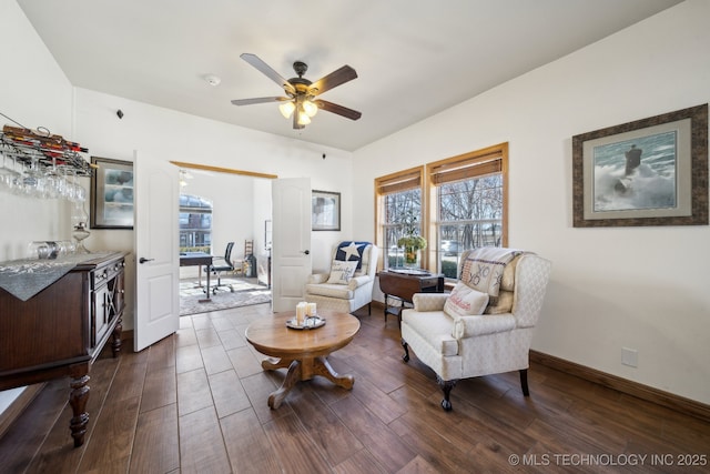 sitting room with ceiling fan and dark hardwood / wood-style floors