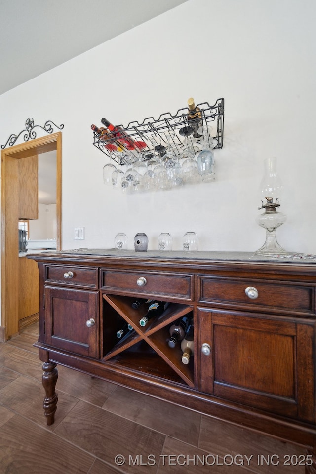 bar featuring dark brown cabinetry